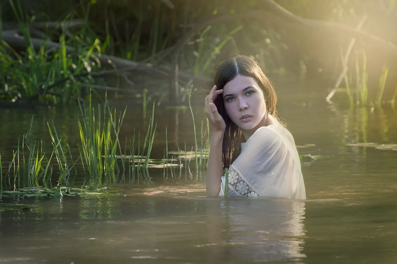 Nana in shallow water beside reeds