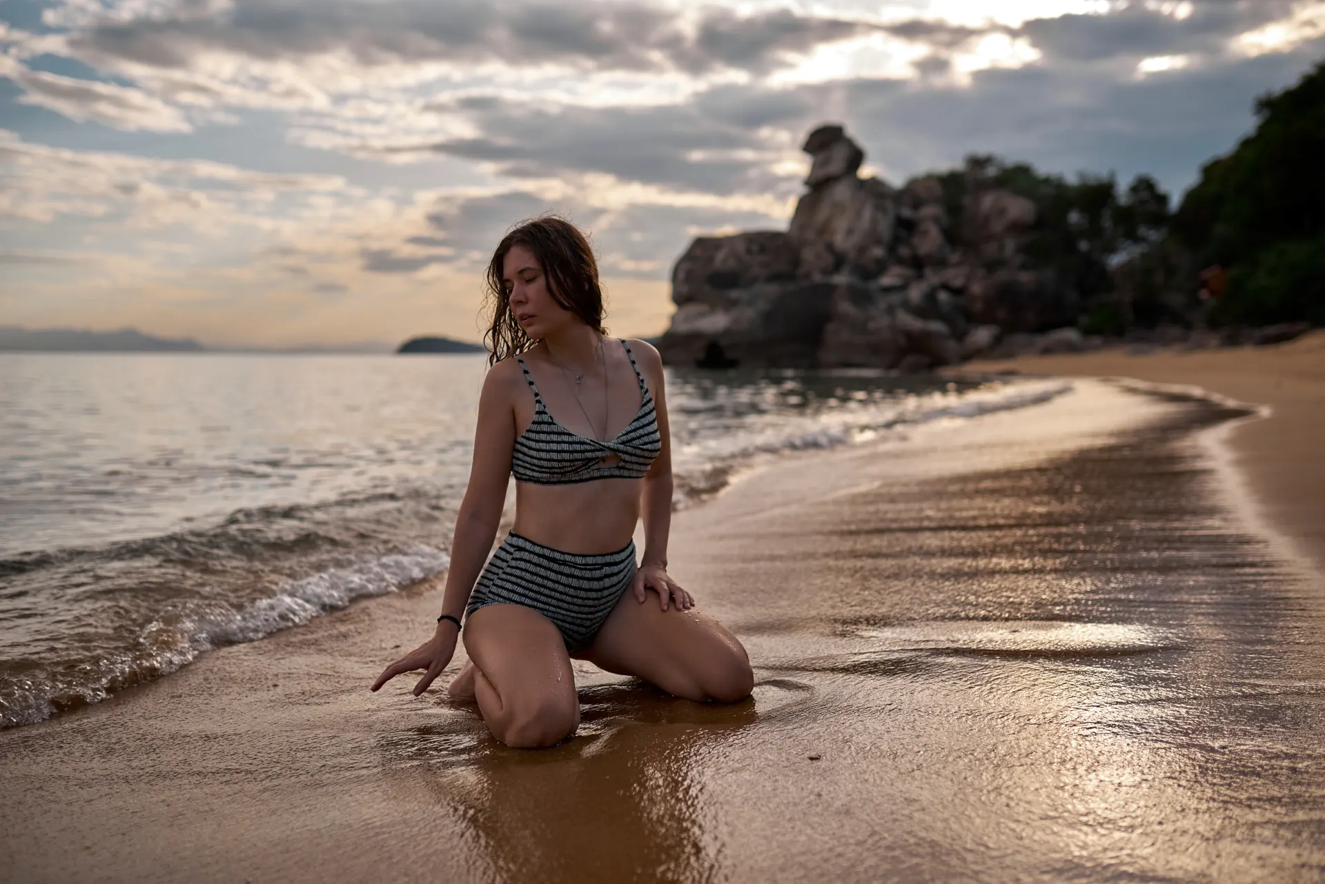 Nana at the water's edge at sunset